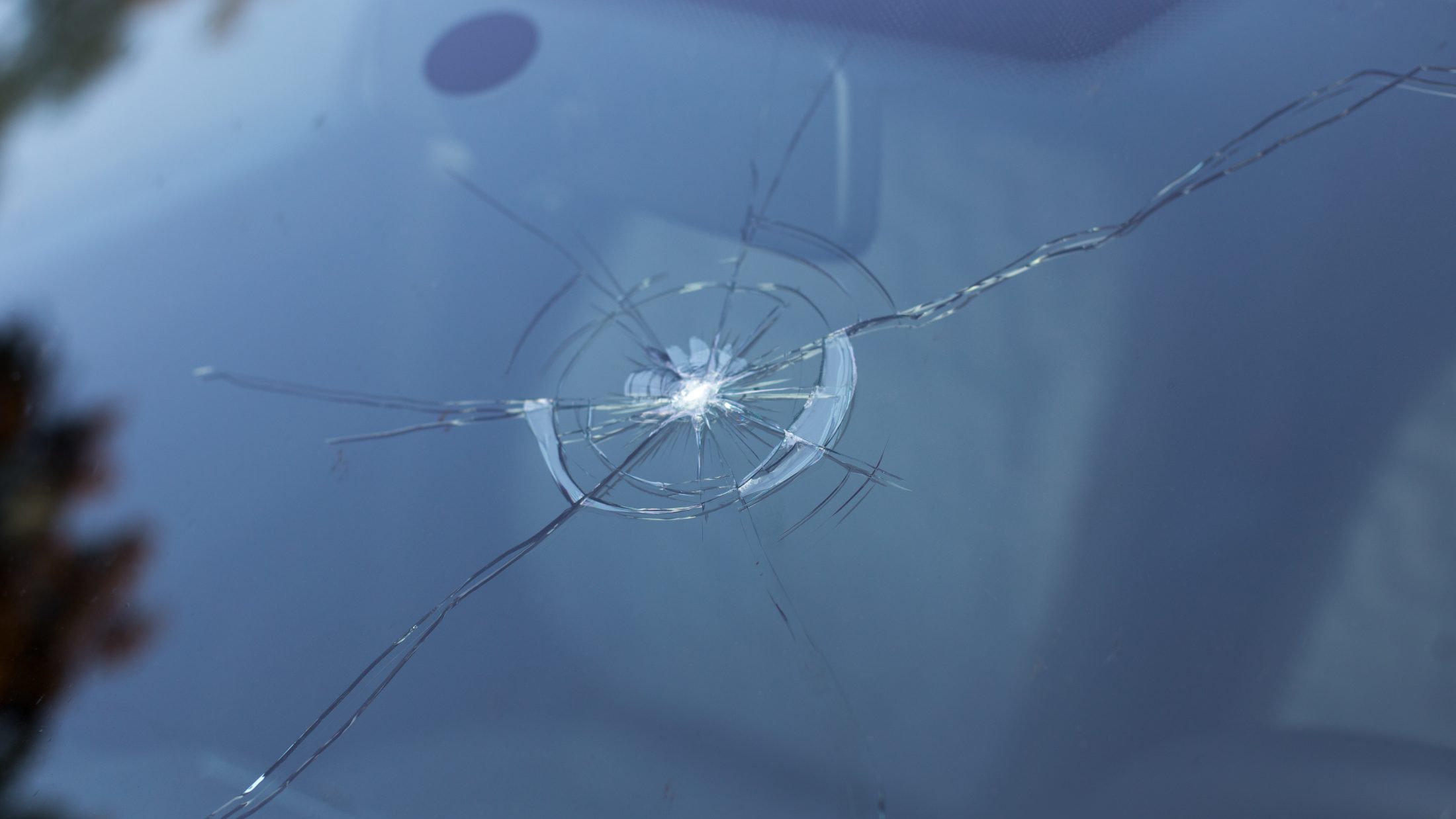 Smashed windscreen of a car damaged glass