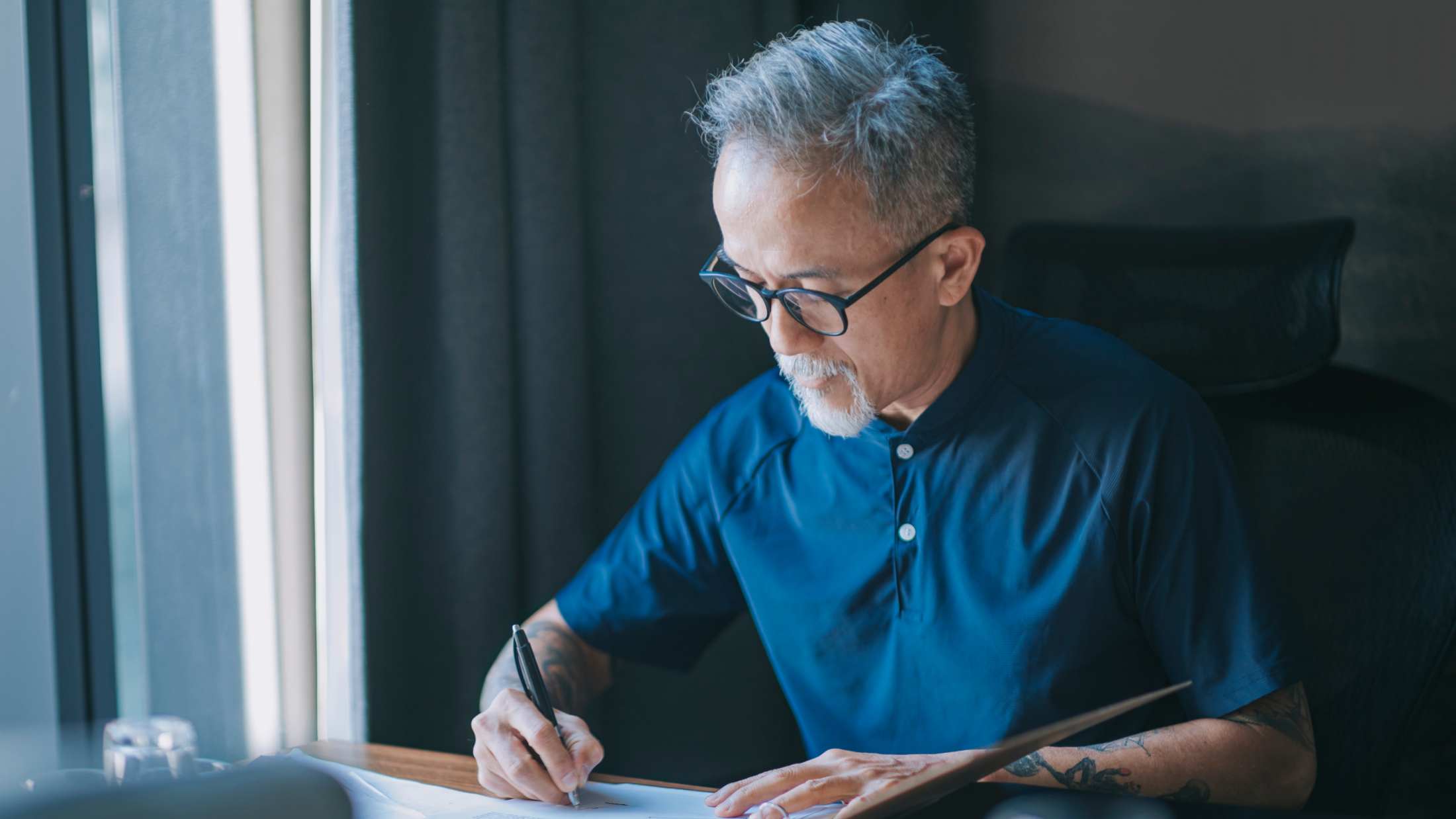 An old man writing a letter