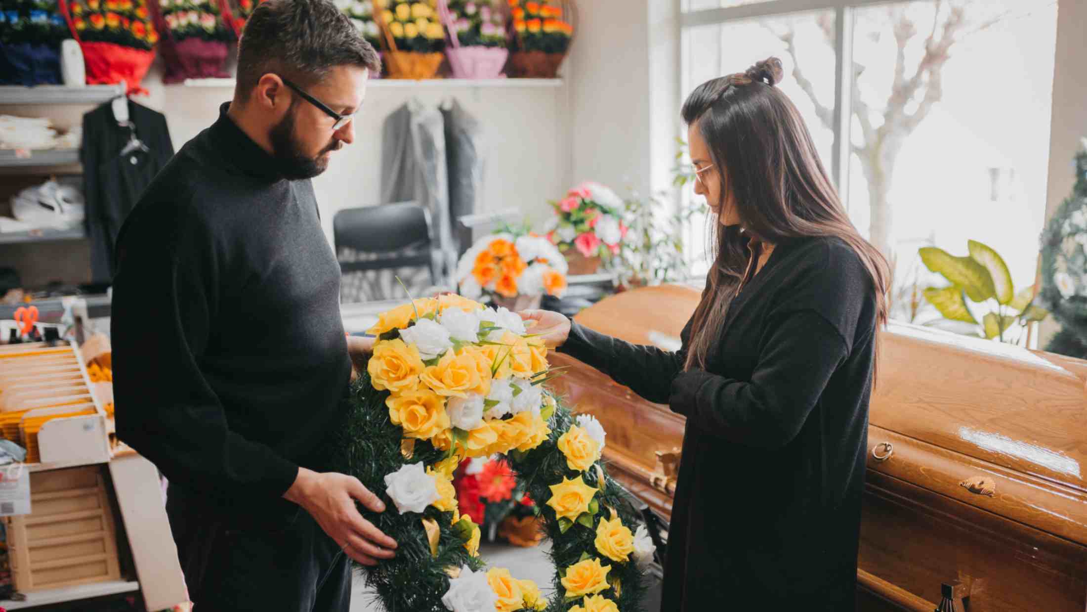 Couple preparing a wreath for funeral